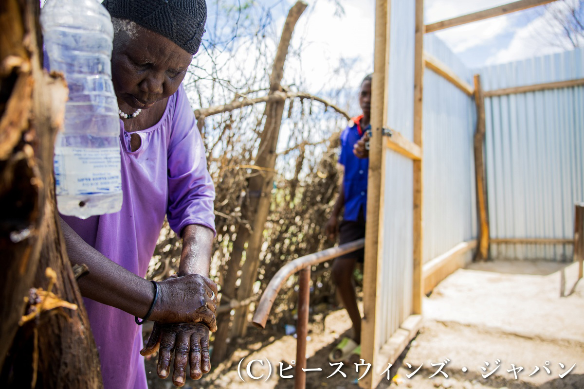 カクマ難民キャンプで自作の手洗い器を用いて手洗いを実践する難民女性 ©ピースウィンズ・ジャパン