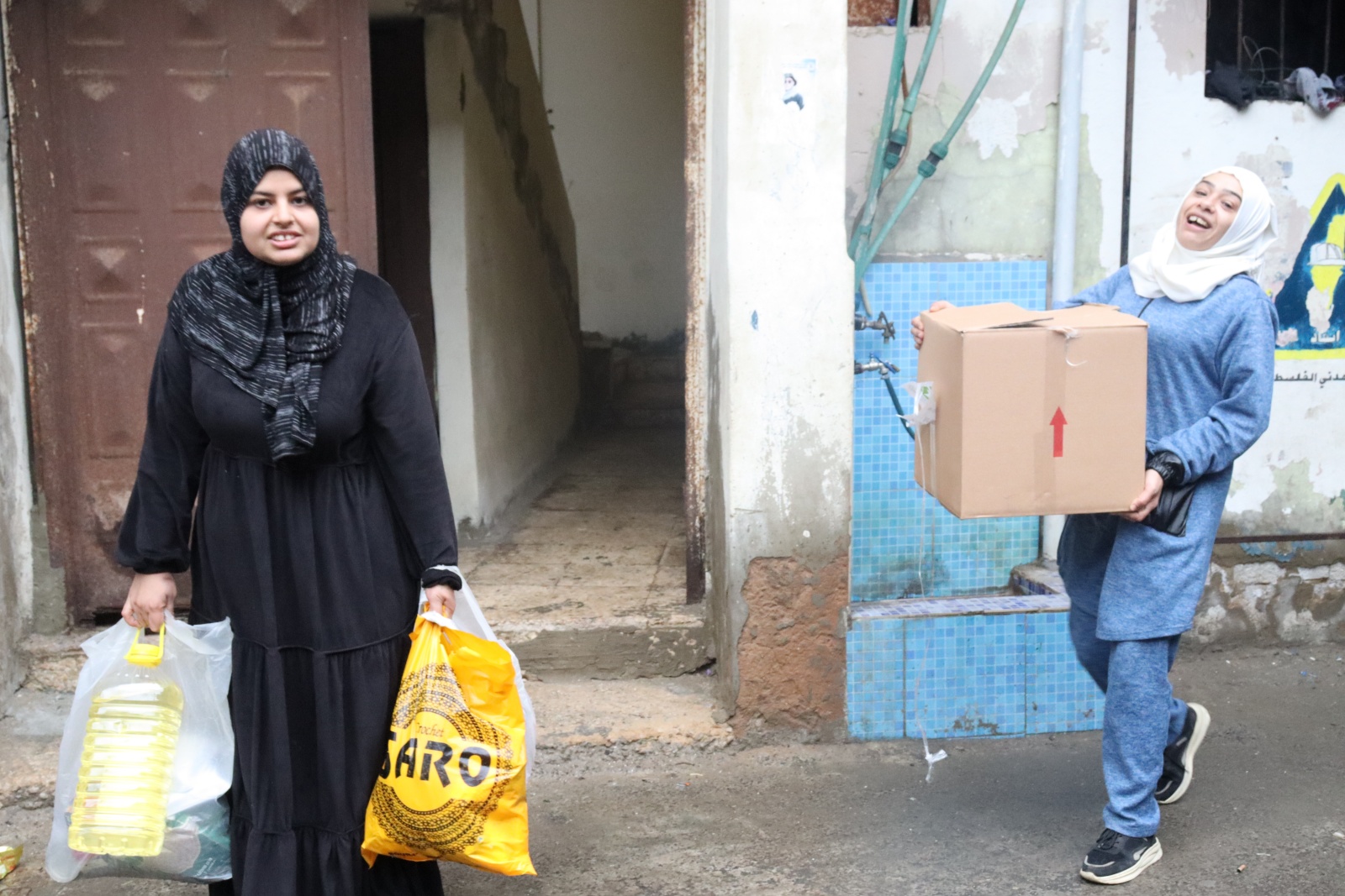 食料を受け取り安どの表情の親子 🄫CCP