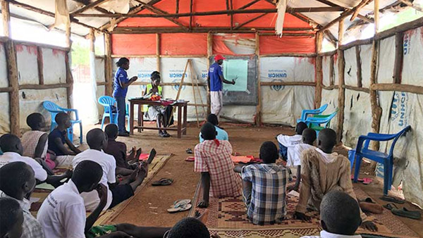 Members of the children's club learn how to make reusable sanitary pads ©Plan International