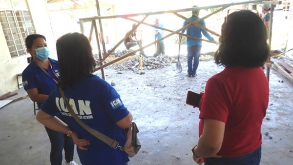 ICAN staff monitoring the restoration work with school officials ©ICAN