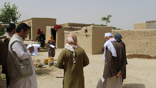 Visiting a potential cash transfer beneficiary household in person to finalize the household's situation in Aman Abad village on April 14, 2022.